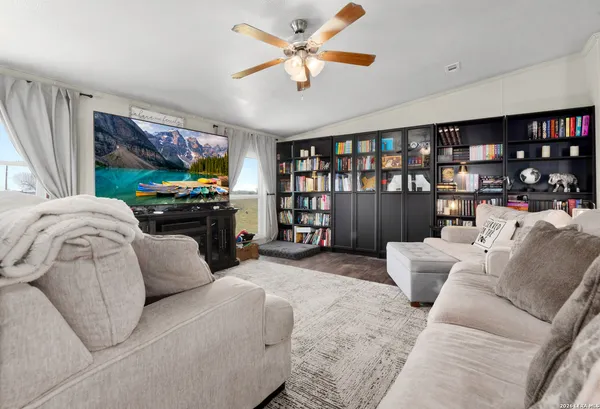 a living room with fireplace furniture and a flat screen tv