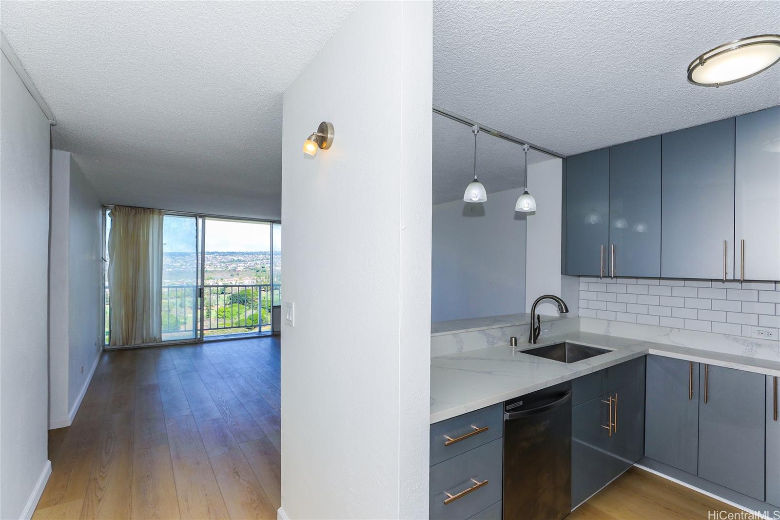 98-410 Koauka Loop, Unit 32C Aiea, HI 96701 - Photo 11 of 25 a kitchen with a sink and a window