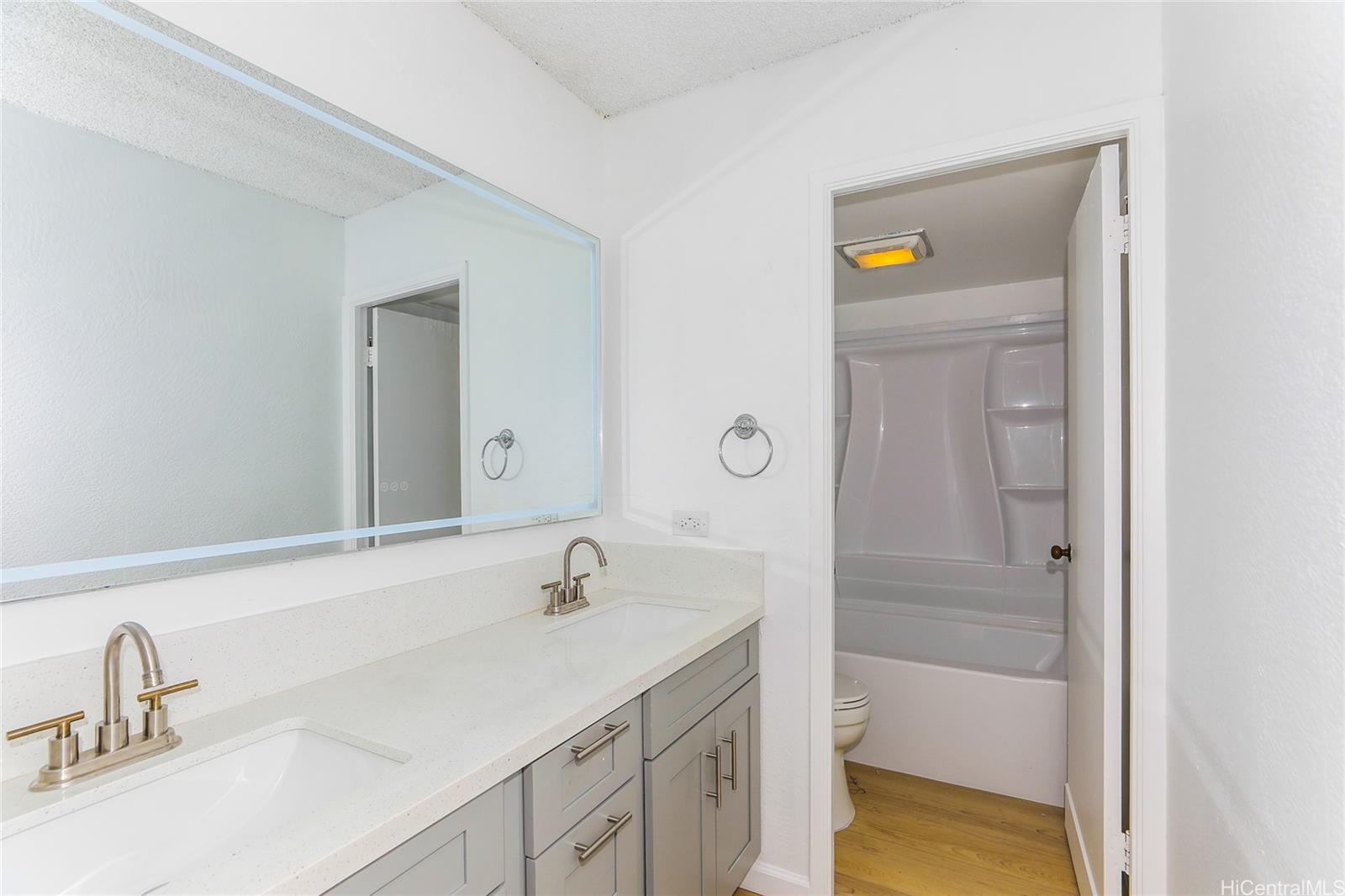 98-410 Koauka Loop, Unit 32C Aiea, HI 96701 - Photo 14 of 25 a bathroom with a sink and a mirror