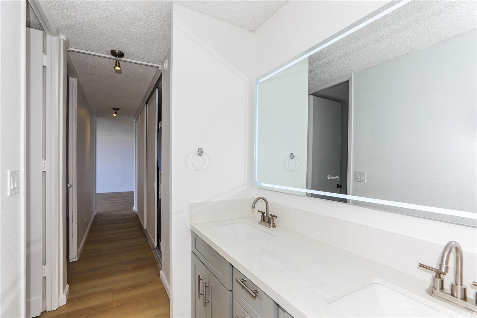 98-410 Koauka Loop, Unit 32C Aiea, HI 96701 - Photo 16 of 25 a bathroom with a sink and mirror