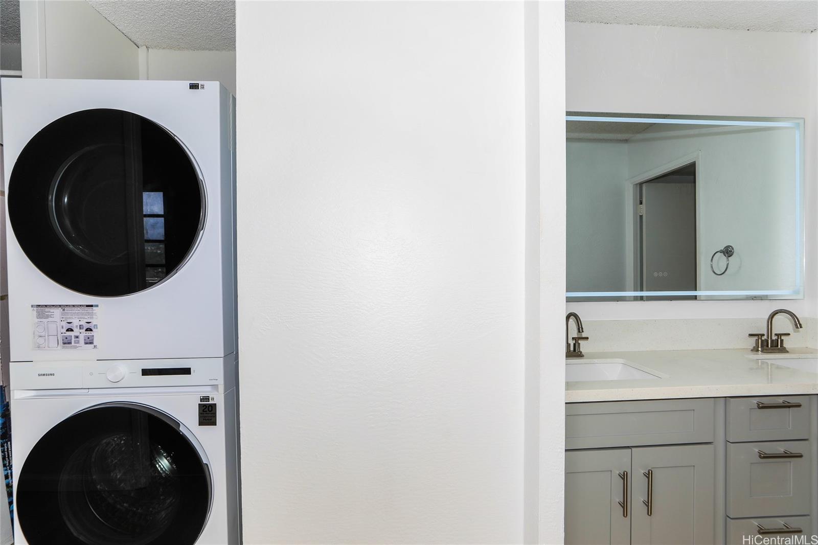 98-410 Koauka Loop, Unit 32C Aiea, HI 96701 - Photo 17 of 25 a bathroom with a sink and a washer