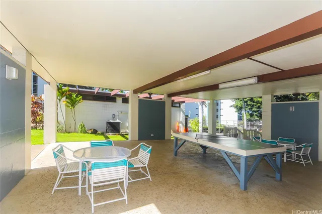 a view of an outdoor dining space with a table and chairs