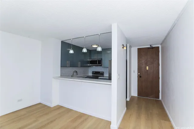 a view of a kitchen cabinets and wooden floor
