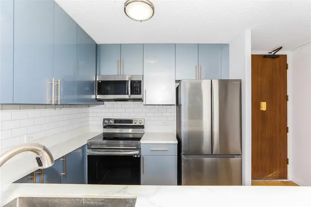 a kitchen with a refrigerator sink and stainless steel appliances