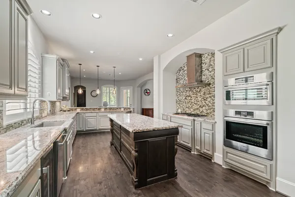 a kitchen with stainless steel appliances granite countertop a stove and a sink