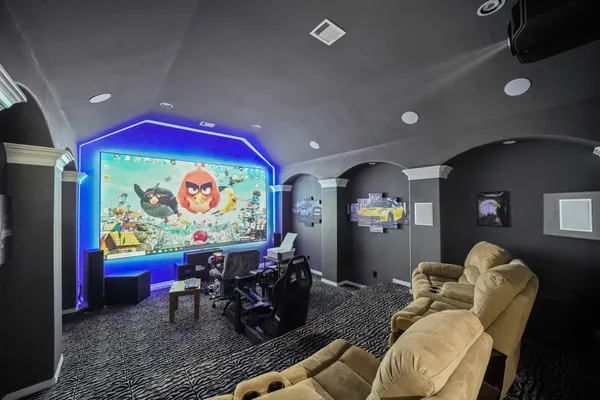 a living room with furniture and wall paintings