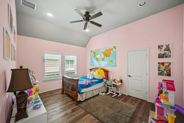 a bedroom with furniture and a wooden floor