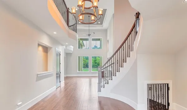 a view of entryway and hall with wooden floor