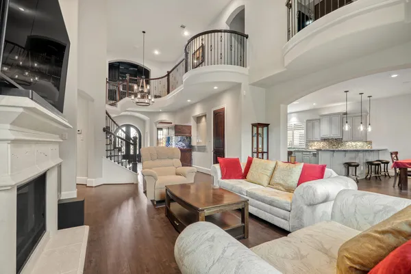 a living room with furniture kitchen view and a flat screen tv