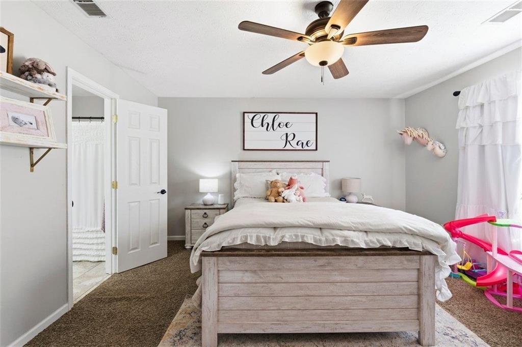 2777 Chickadee Drive Monroe, GA 30655 - Photo 28 of 36 a bedroom with a bed and a chandelier