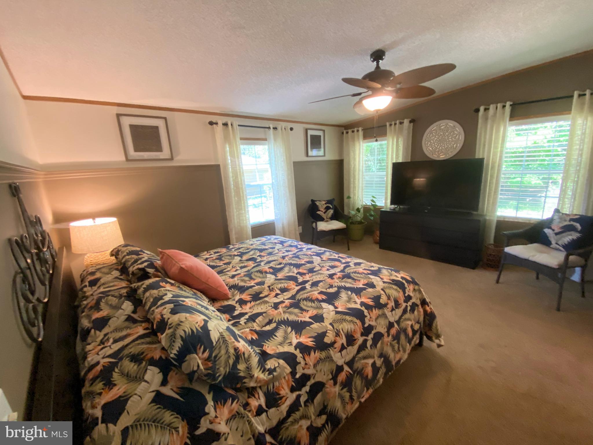 26750 North Rim Road, Unit 975 Long Neck, DE 19966 - Photo 16 of 44 a bedroom with a bed and glass window