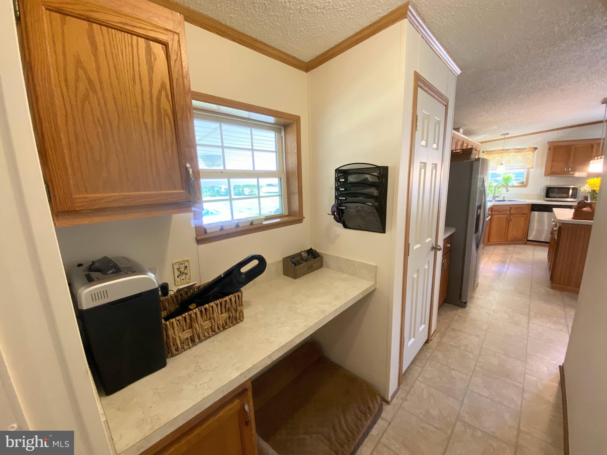 26750 North Rim Road, Unit 975 Long Neck, DE 19966 - Photo 27 of 44 a kitchen with a refrigerator and a sink