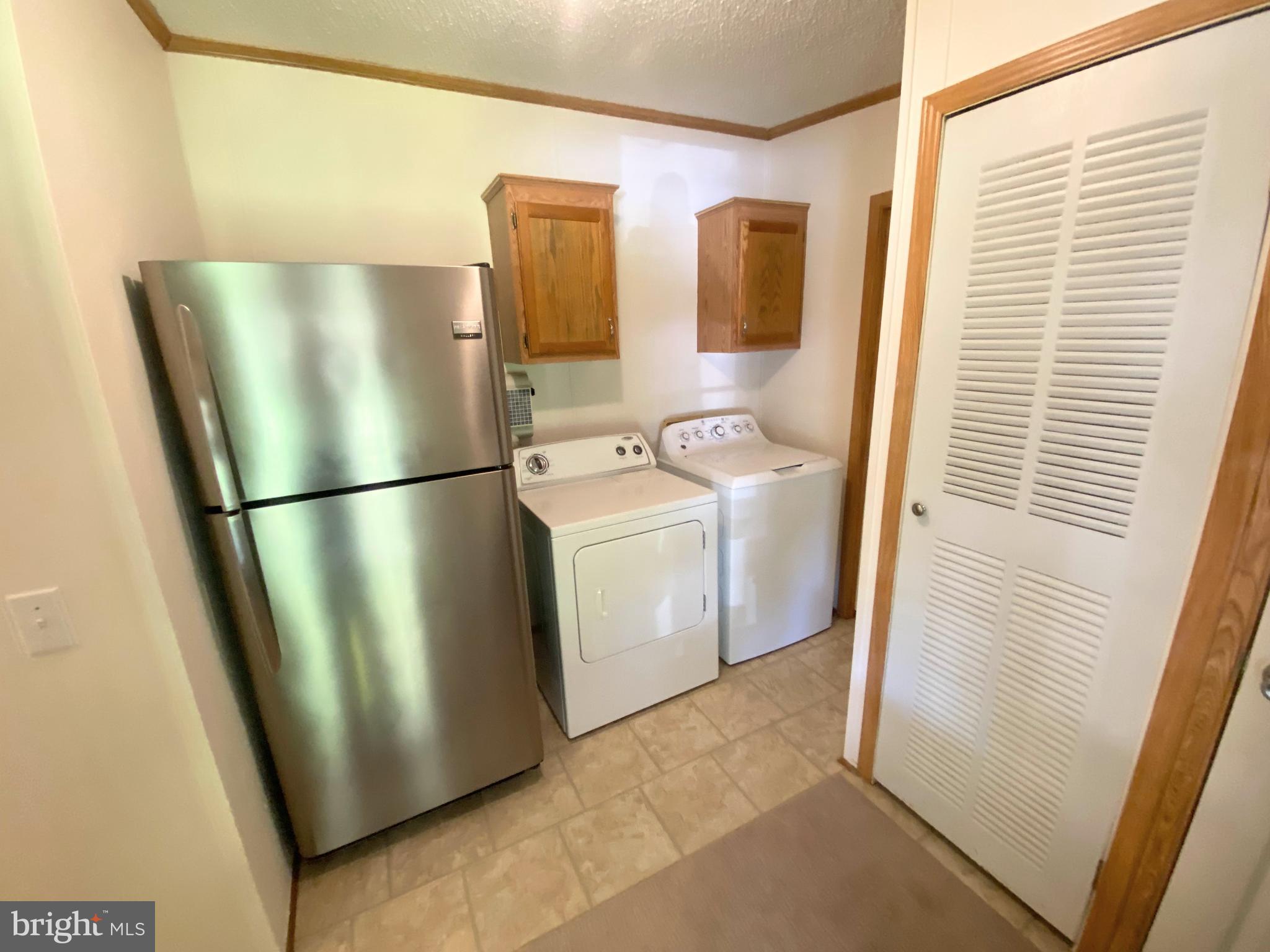 26750 North Rim Road, Unit 975 Long Neck, DE 19966 - Photo 28 of 44 a utility room with washer and dryer