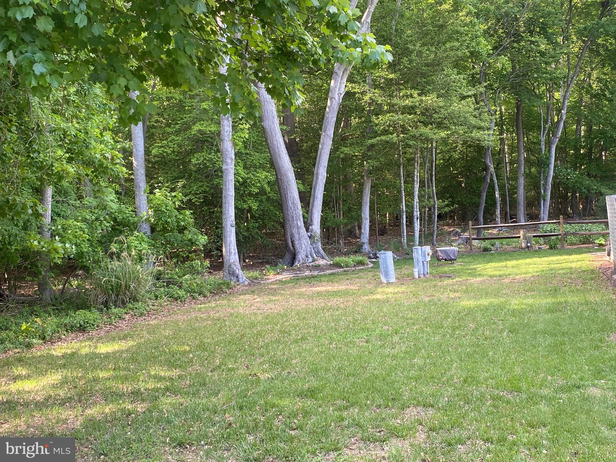 26750 North Rim Road, Unit 975 Long Neck, DE 19966 - Photo 32 of 44 a view of a house with backyard and a tree