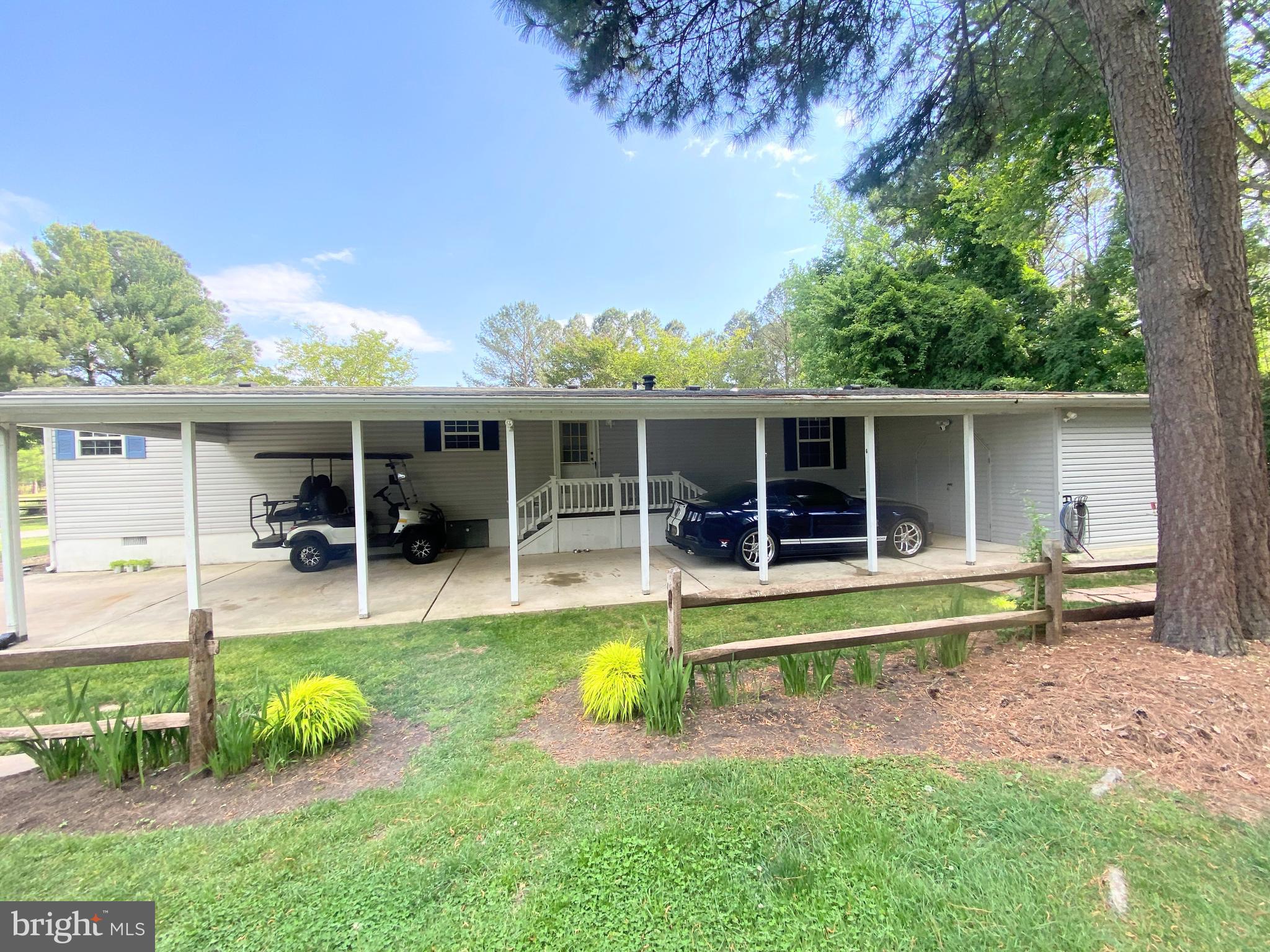 26750 North Rim Road, Unit 975 Long Neck, DE 19966 - Photo 5 of 44 front view of a house with swimming pool and porch