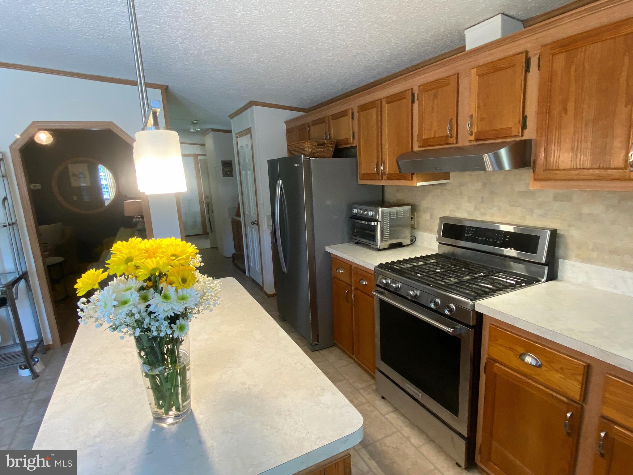 26750 North Rim Road, Unit 975 Long Neck, DE 19966 - Photo 9 of 44 a kitchen with stainless steel appliances granite countertop a stove a refrigerator a sink a stove and dishwasher