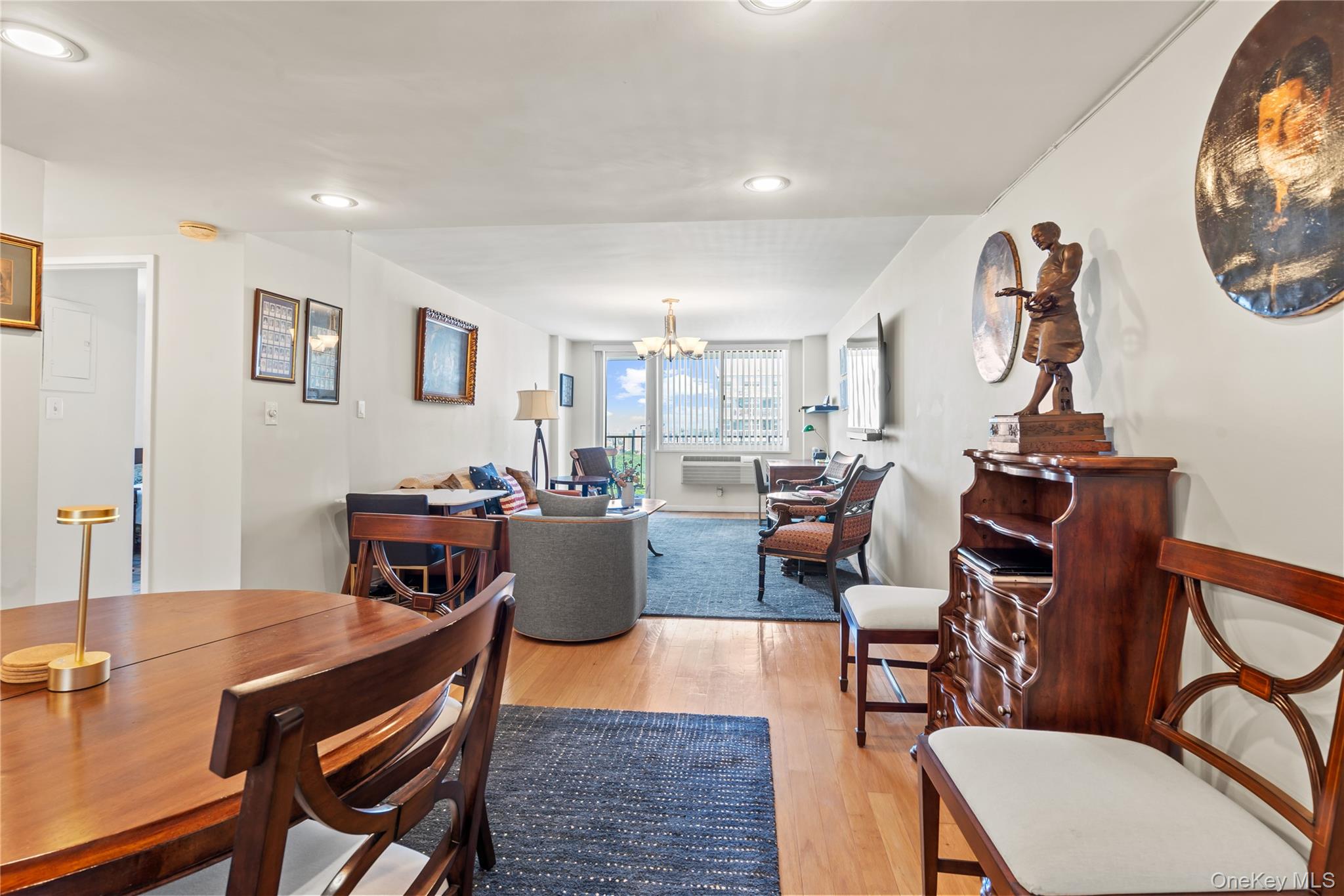118-18 Union Turnpike, Unit 19G Queens, NY 11415 - Photo 2 of 16 Dining space with light wood finished floors, a chandelier, and recessed lighting
