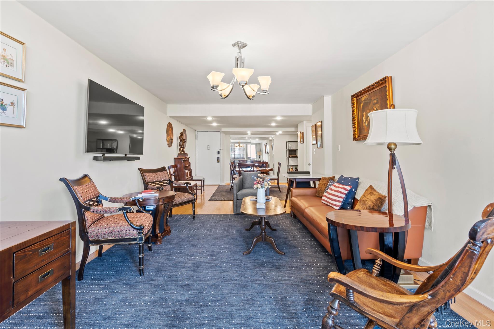 118-18 Union Turnpike, Unit 19G Queens, NY 11415 - Photo 5 of 16 Living room featuring a chandelier