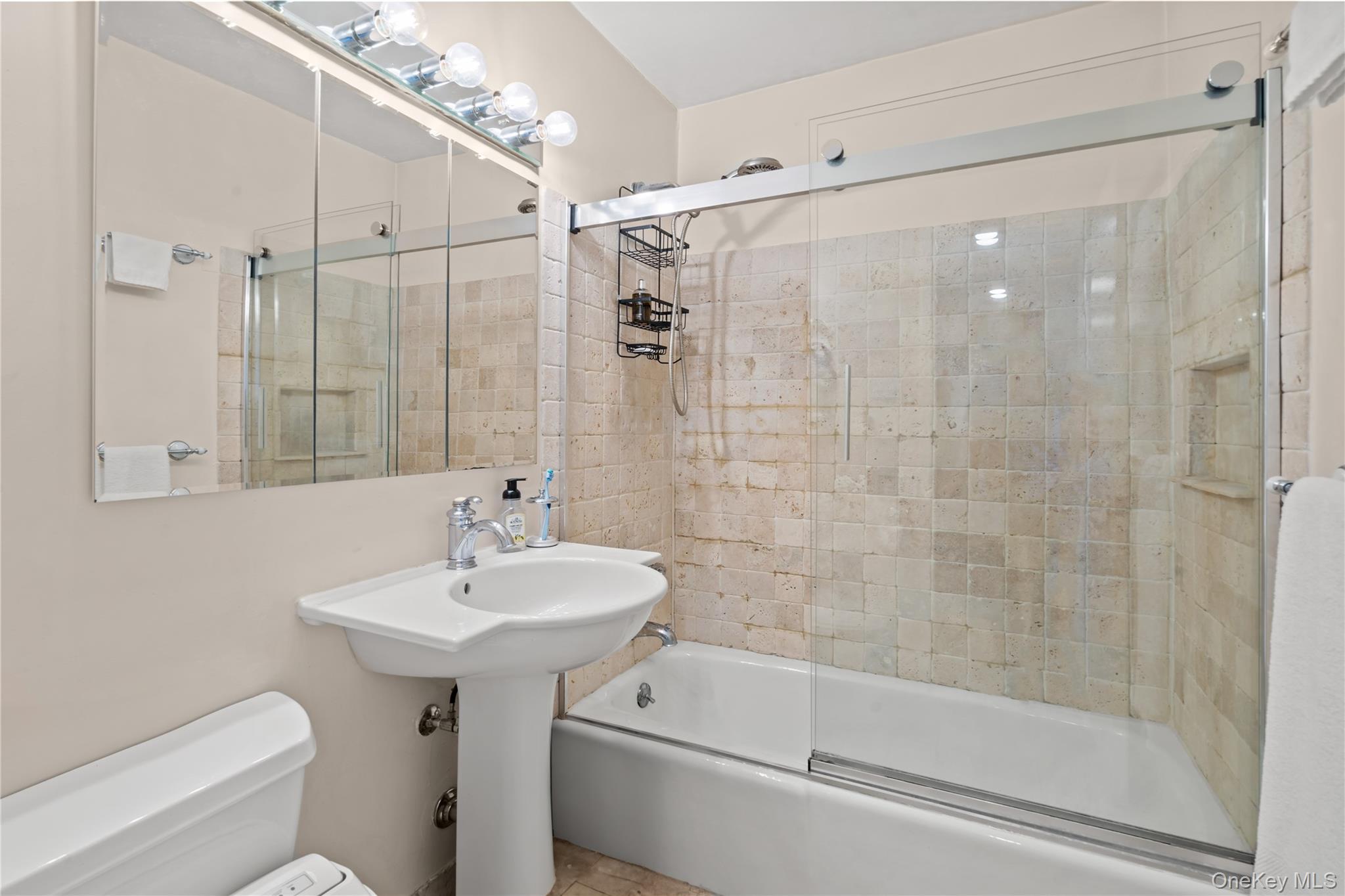 118-18 Union Turnpike, Unit 19G Queens, NY 11415 - Photo 8 of 16 Full bathroom with enclosed tub / shower combo and toilet