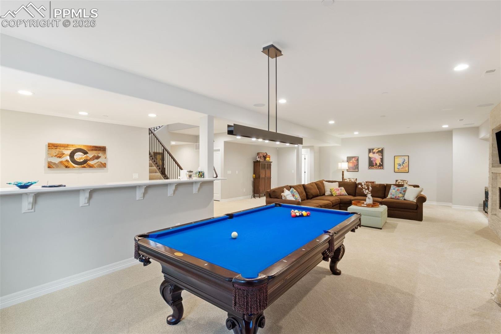 5318 Rocking Tree Grove Colorado Springs, CO 80906 - Photo 30 of 49 The open flow from the billiards area to the bar and media space allows for dynamic, large-scale entertaining where family and/or guests can mingle freely across different activities