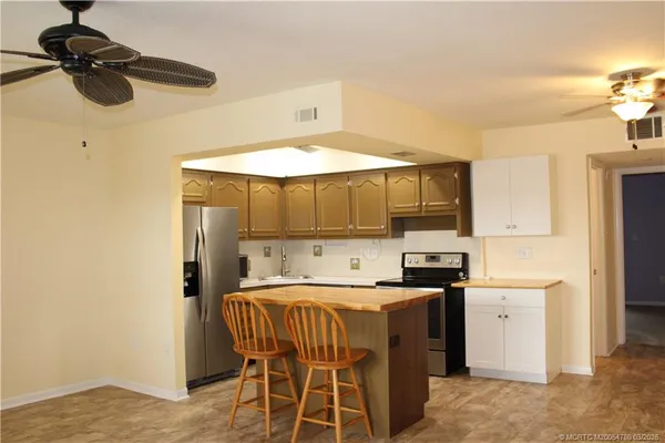 a kitchen that has a sink a stove and a microwave