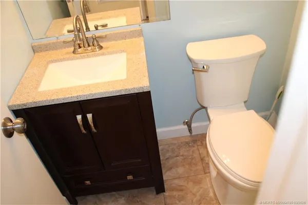 a bathroom with a toilet and a mirror