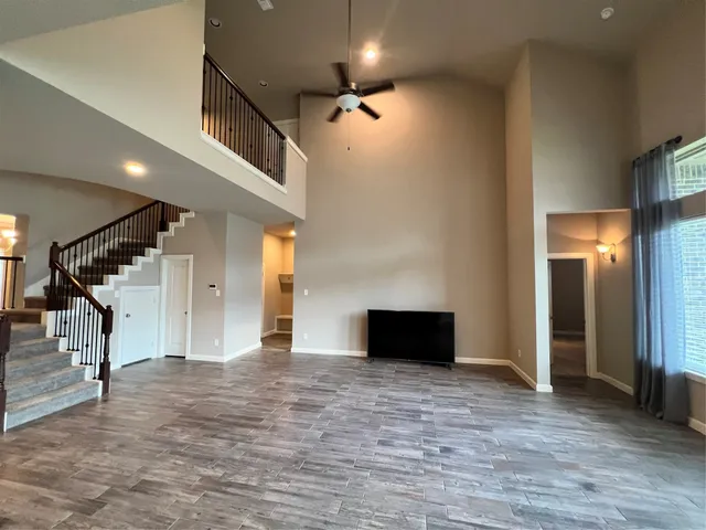 a view of an empty room with glass door and a window