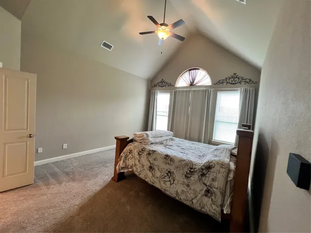 a bedroom with a bed and window