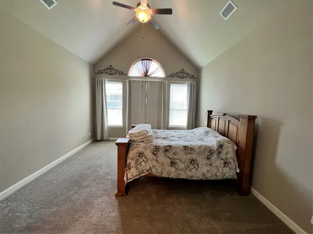 a spacious bathroom with a granite countertop toilet sink and mirror