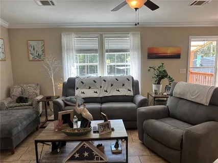 a living room with furniture and a chandelier