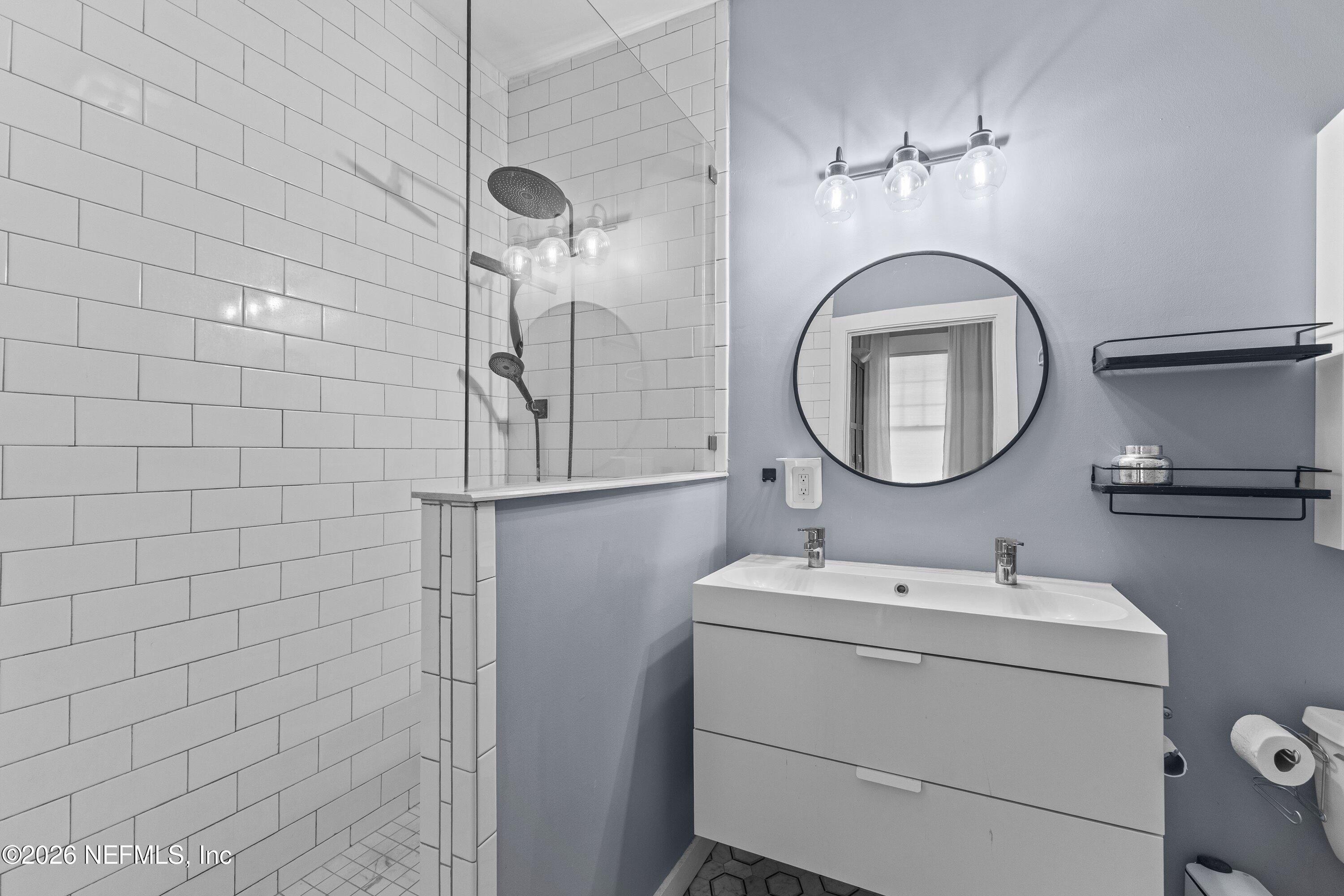 1544 Perry Street Jacksonville, FL 32206 - Photo 23 of 43 a bathroom with a toilet a sink and mirror