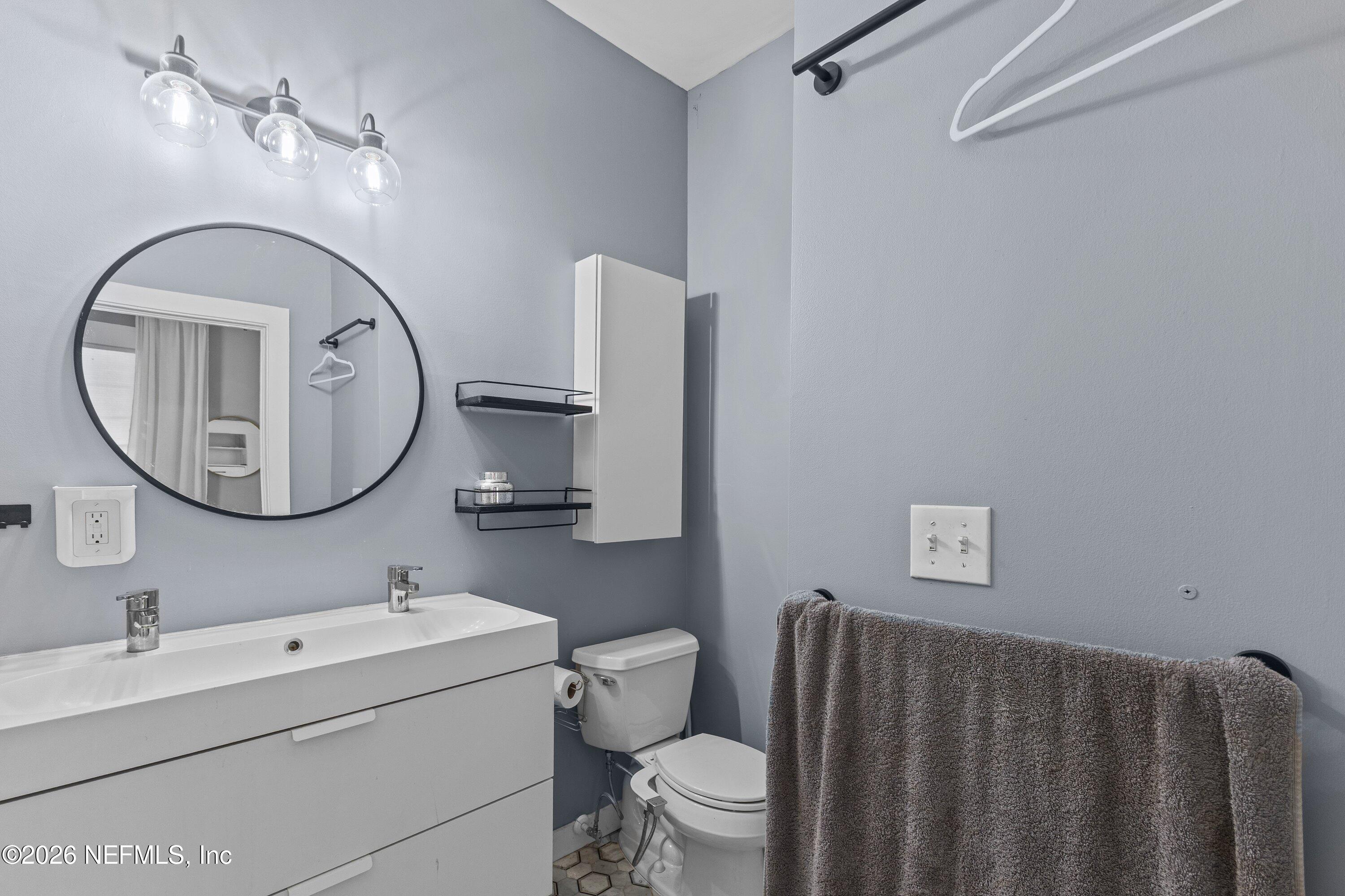 1544 Perry Street Jacksonville, FL 32206 - Photo 24 of 43 a bathroom with a toilet a sink and a mirror