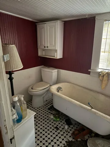 a bathroom with a toilet a sink and bathtub