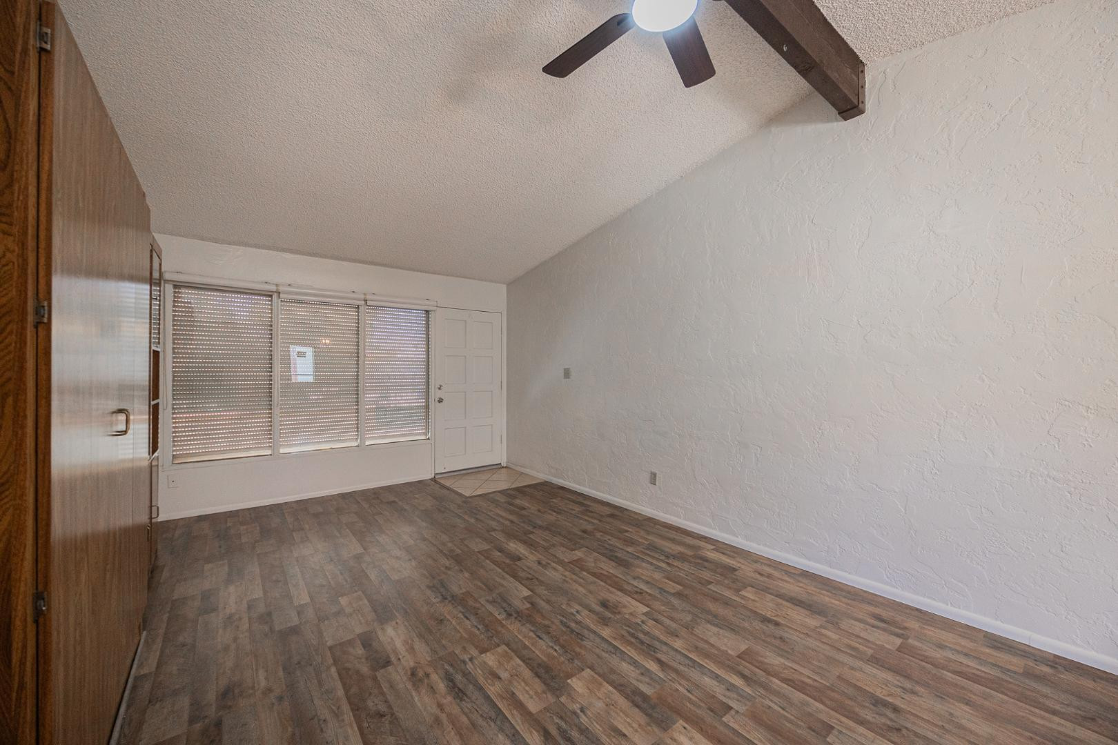 609 South Power Road, Unit 338 Mesa, AZ 85206 - Photo 7 of 24 an empty room with wooden floor and windows