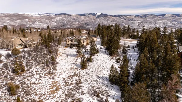 an aerial view of residential house and covered with snow