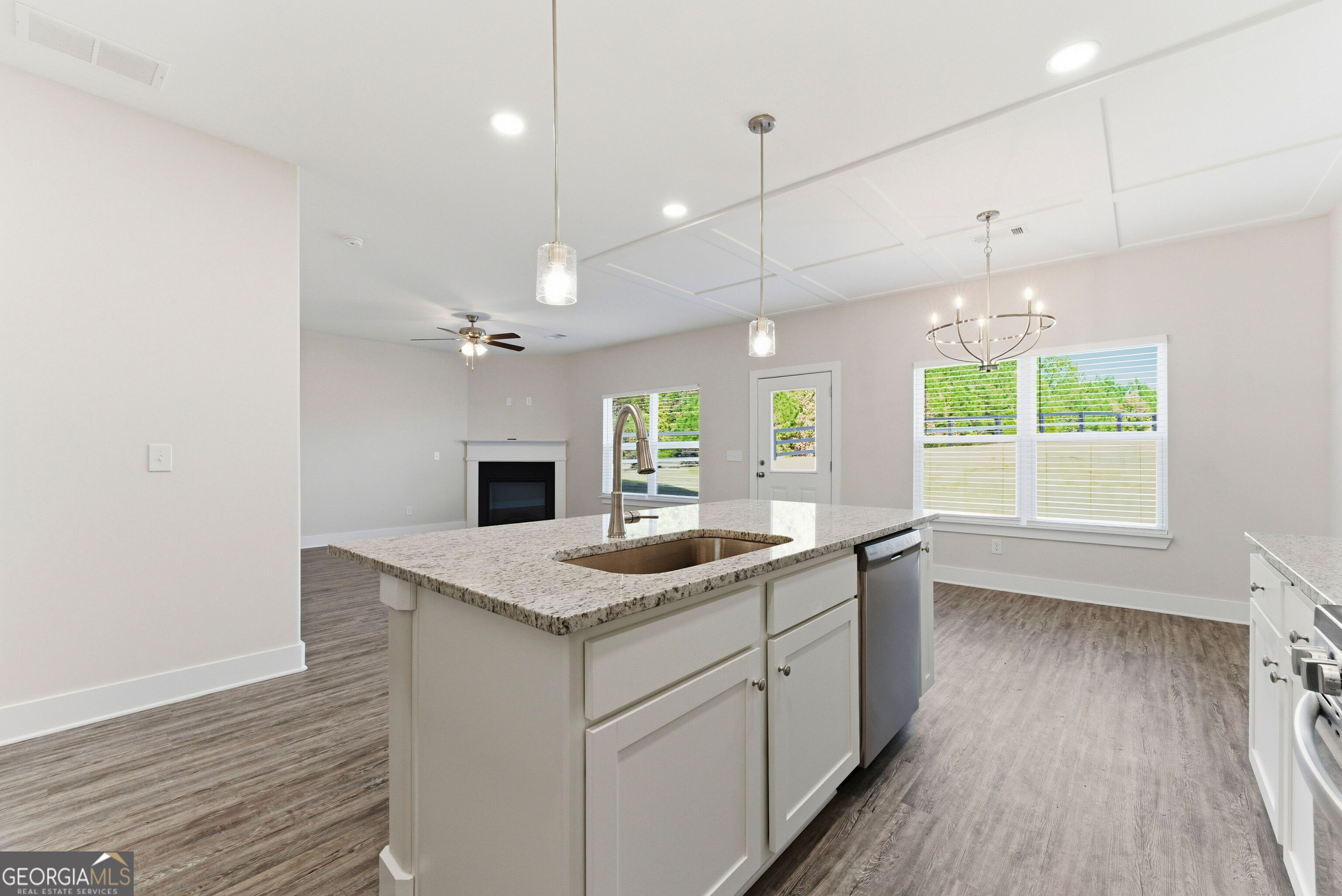 11209 Cornerstone Lane Hampton, GA 30228 - Photo 17 of 38 a kitchen with a sink chandelier and wooden floor