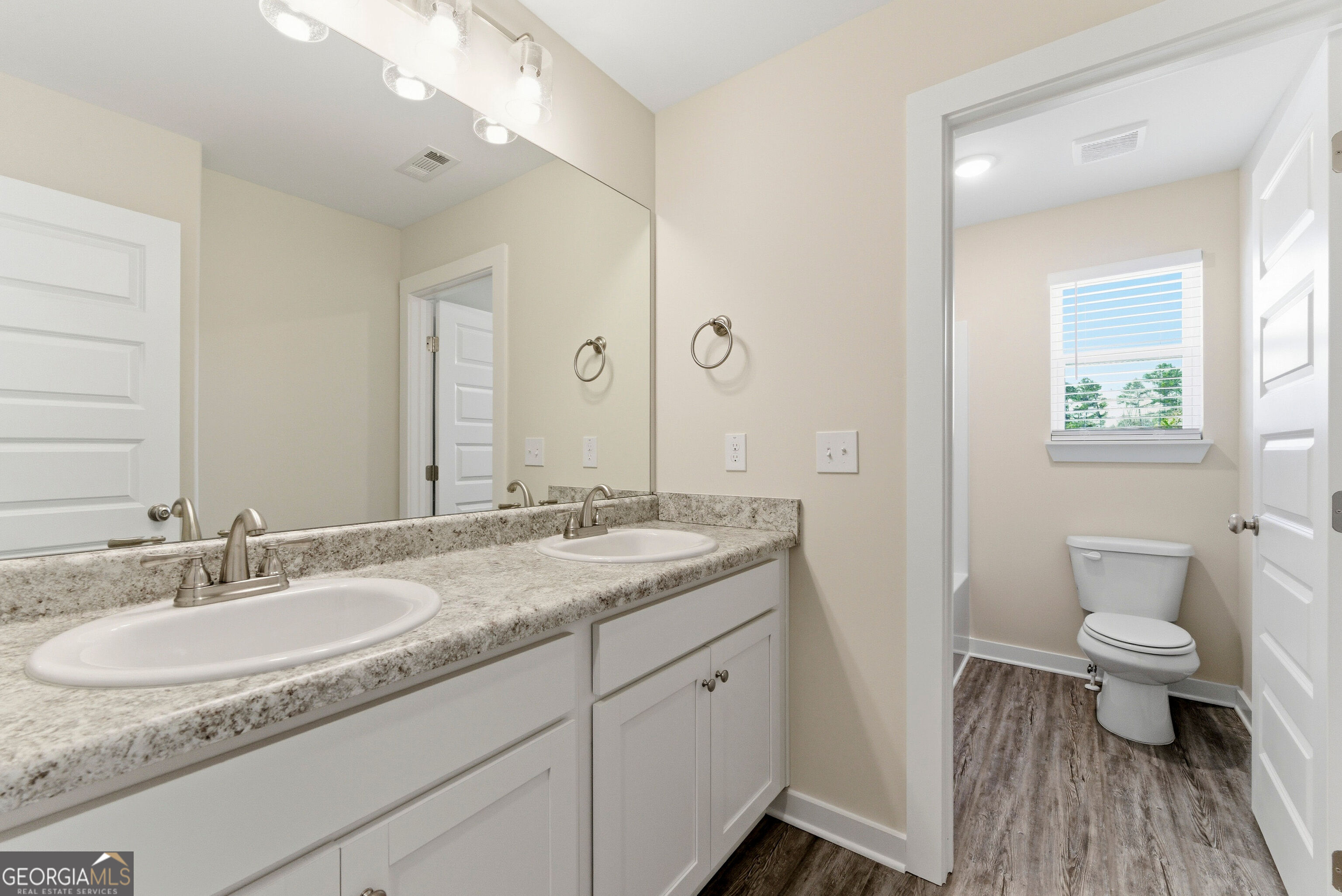 11209 Cornerstone Lane Hampton, GA 30228 - Photo 25 of 38 a bathroom with a granite countertop sink a toilet and a mirror