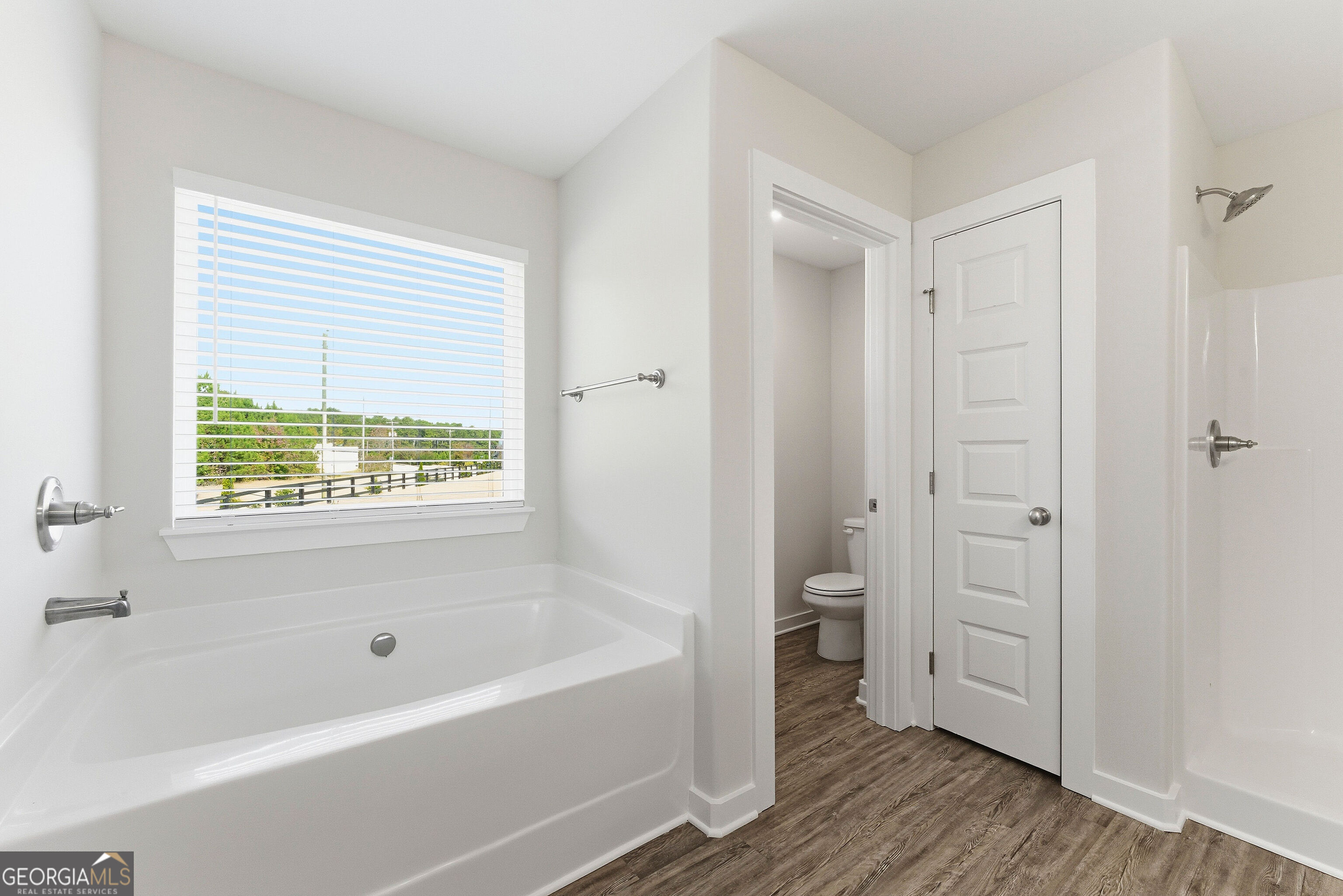 11209 Cornerstone Lane Hampton, GA 30228 - Photo 31 of 38 a bathroom with a bathtub shower and a toilet