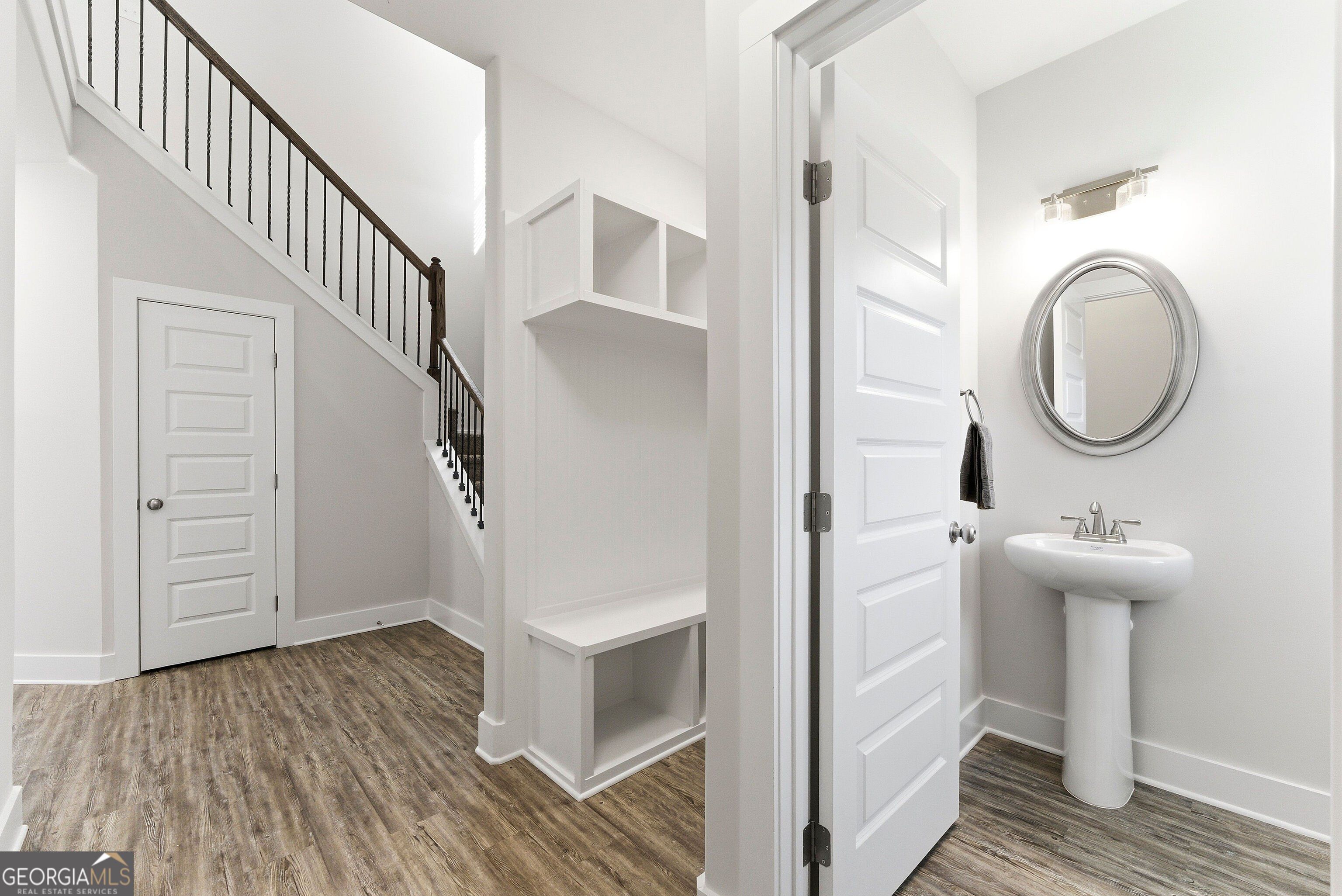 11209 Cornerstone Lane Hampton, GA 30228 - Photo 4 of 38 a view of a hallway with wooden floor and staircase