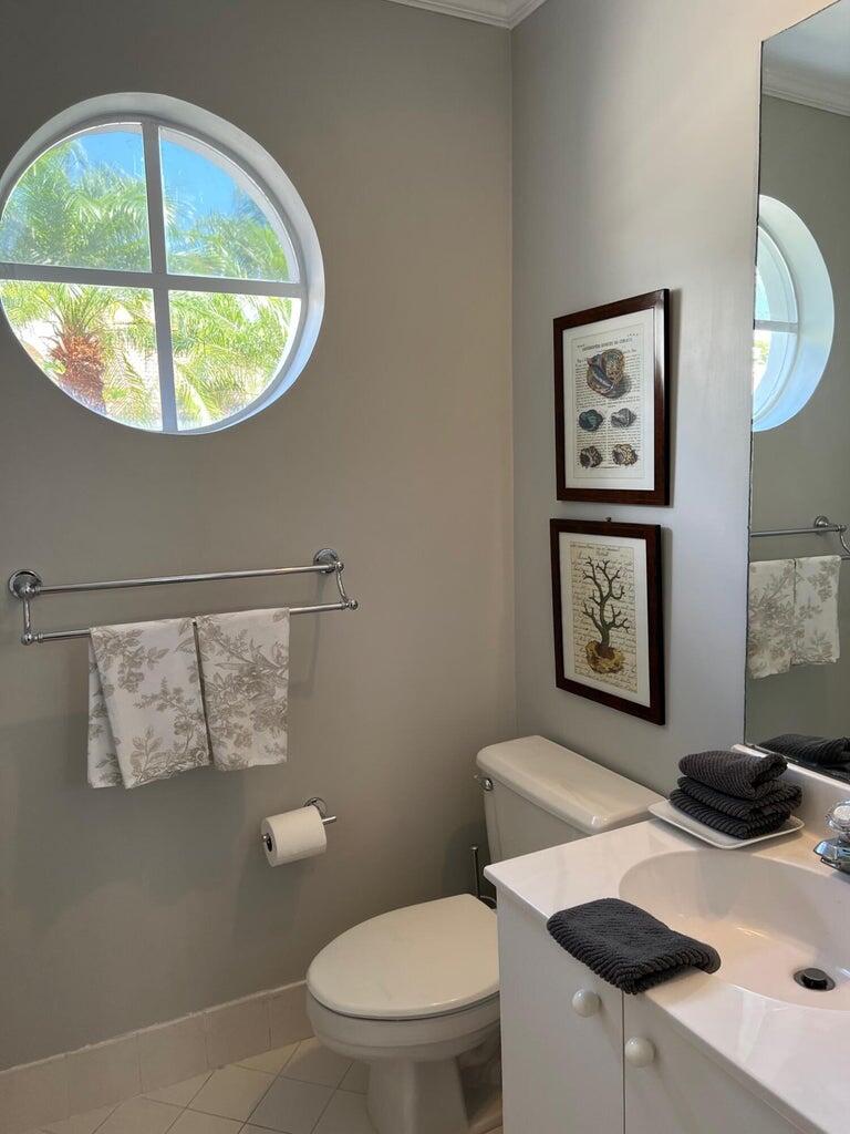 17275 Ventana Drive Boca Raton, FL 33487 - Photo 9 of 9 a bathroom with a toilet a sink and a mirror