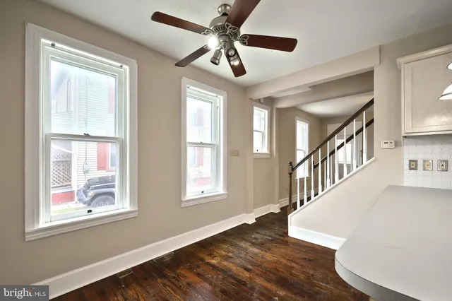 a view of an entryway with wooden floor