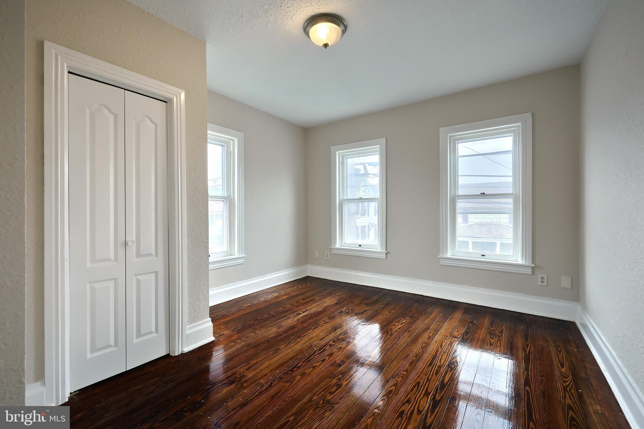 513 Stock Street Hanover, PA 17331 - Photo 22 of 30 an empty room with wooden floor and windows