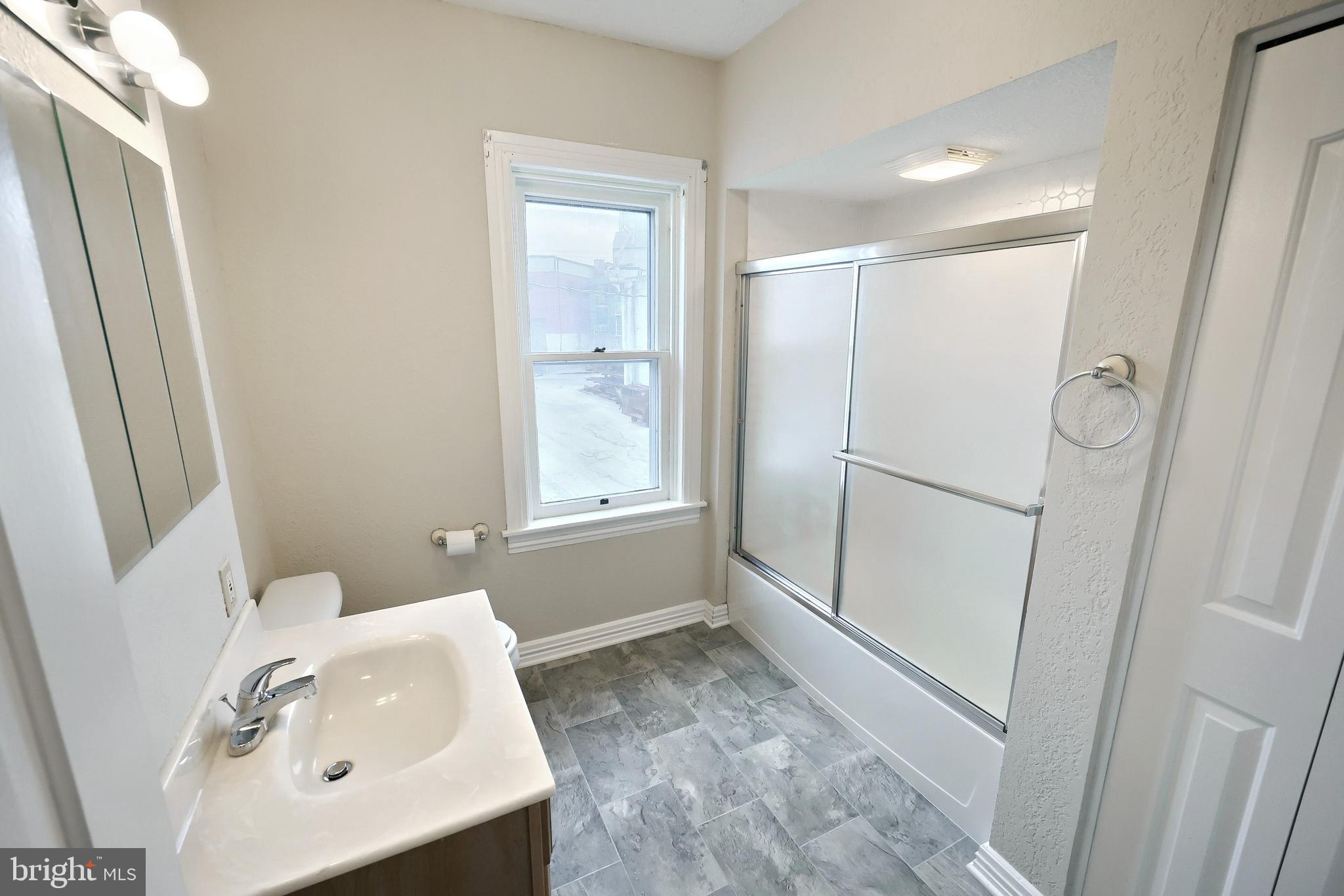 513 Stock Street Hanover, PA 17331 - Photo 28 of 30 a bathroom with a sink a window and shower