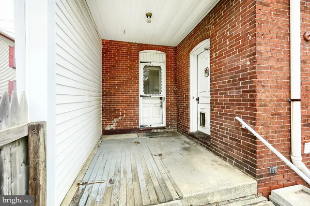 a view of a house with a door and wooden floor