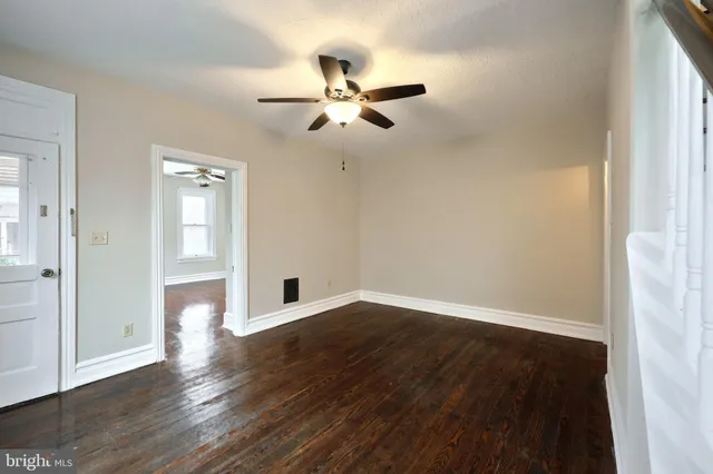 wooden floor in an empty room with a window