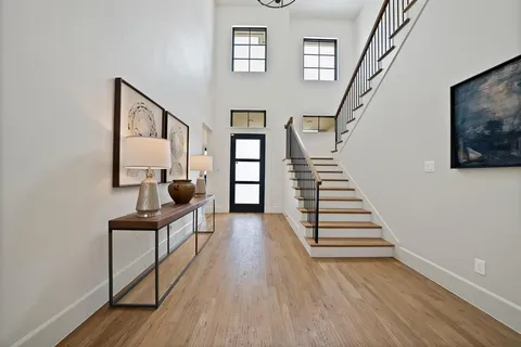 a view of entryway with wooden floor and stairs