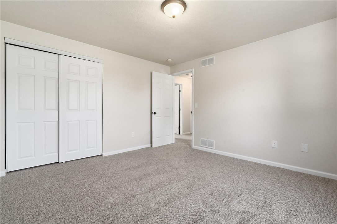 1353 Foust Road Xenia, OH 45385 - Photo 42 of 50 This spacious bedroom offers comfortable carpet flooring and ample closet space for effortless living.