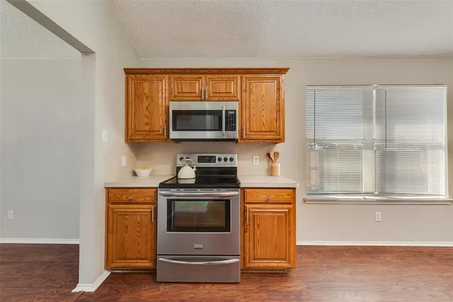 a kitchen with a stove and a microwave