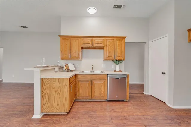 a kitchen with stainless steel appliances a stove a sink and a refrigerator