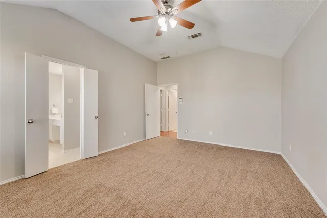 a view of an empty room with a ceiling fan